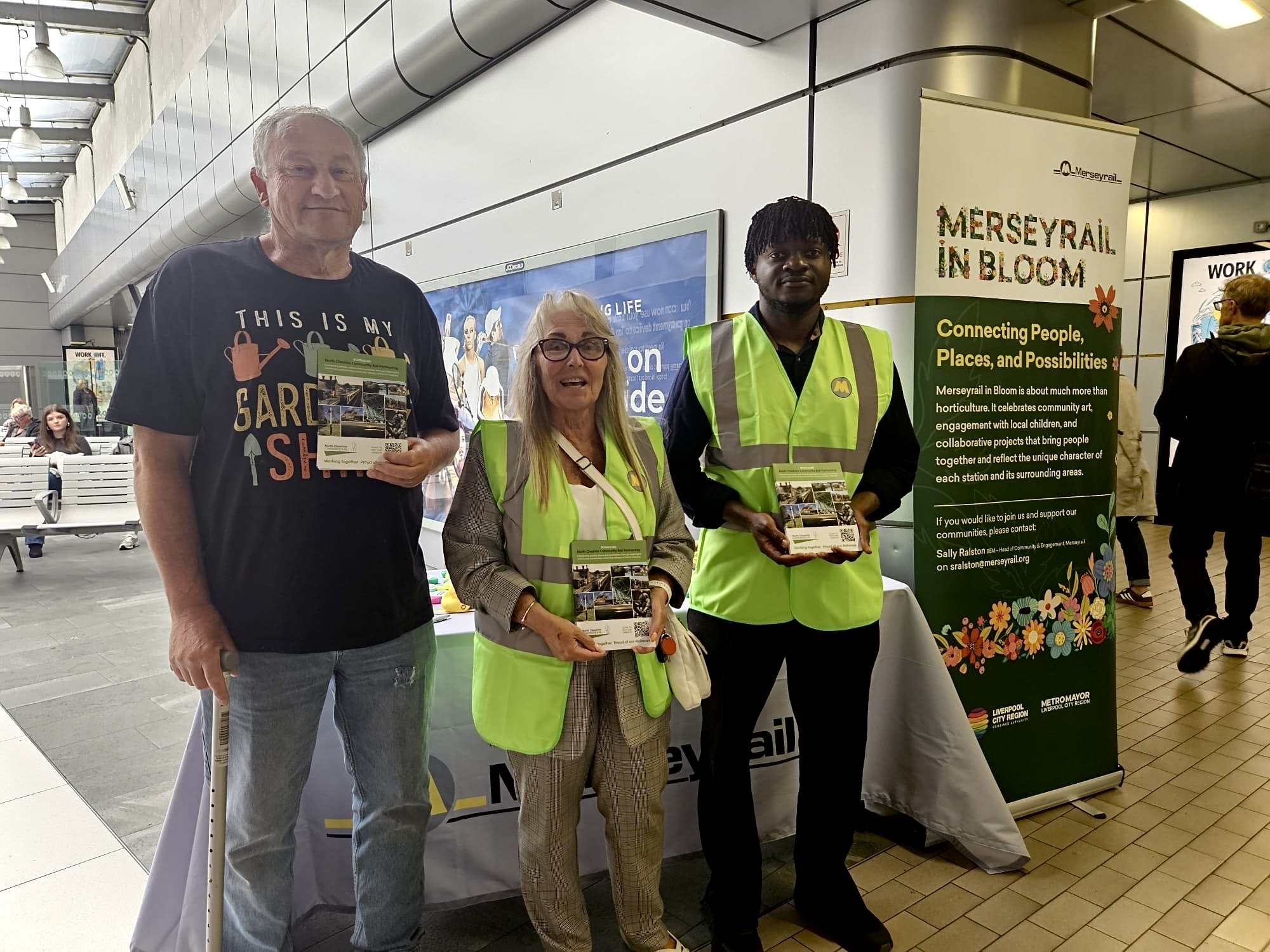 Peter Brown, Babajide Lawal and Community Rail Development Officer Chris Kinsella promoting Merseyrail in Bloom during Community Rail Week at Liverpool Central Station.
